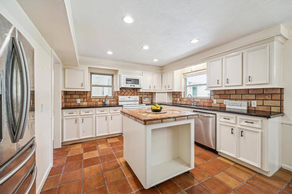 Kitchen with granite countertops and Saltillo tile and movable island on wheels!