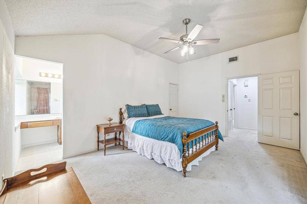 High ceilings in the primary suite as well as a sliding door to the covered patio!
