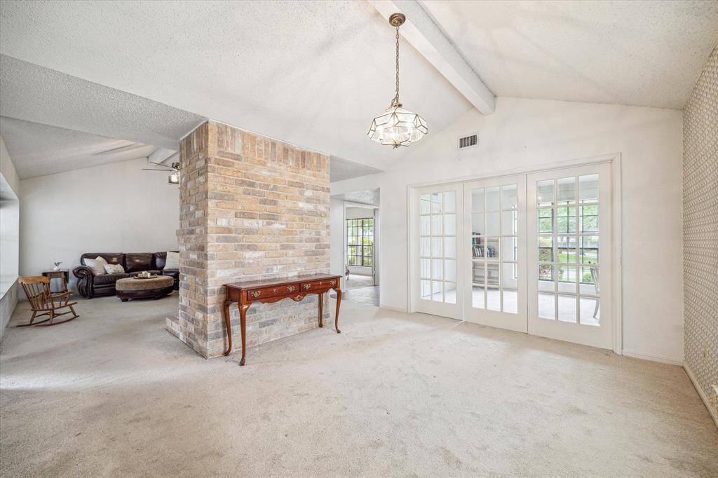 Dining and living spaces are only separated by the fireplace.