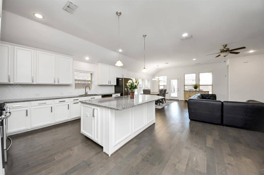A large center island provides ample prep space and casual seating, making it perfect for everything from morning coffee to entertaining guests.