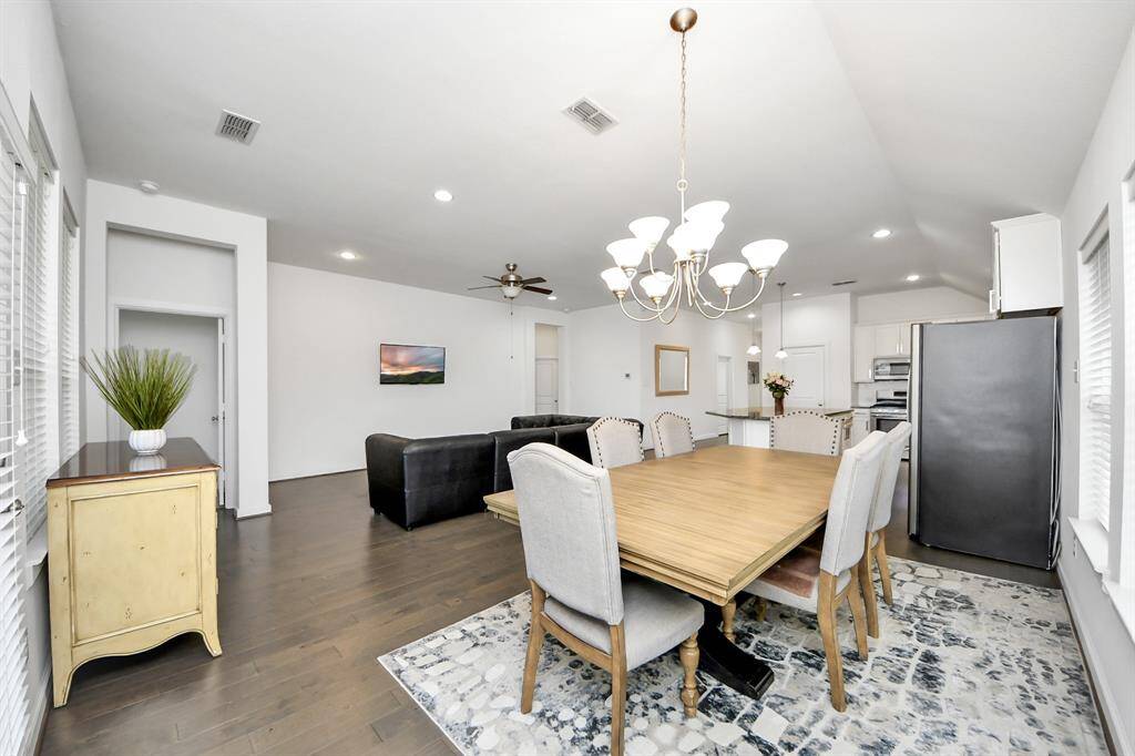 Step inside to find a beautifully appointed kitchen at the heart of the home, complete with sleek countertops, ample cabinetry, and a central island that flows into the adjacent dining area.