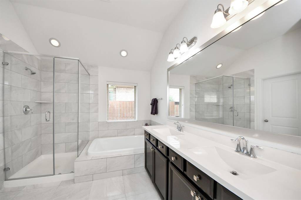 It boasts a spa-inspired ensuite bathroom with a deep soaking tub, a separate walk-in shower, dual vanities, and an oversized walk-in closet to meet all your storage needs.
