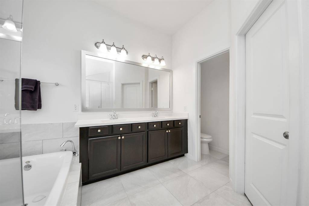 Just steps away, a spacious walk-in closet completes the suite, offering generous storage and seamless organization.