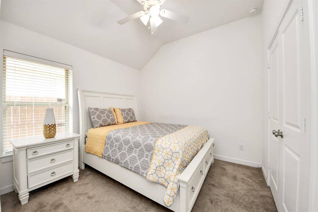Bright and cozy secondary bedroom with ample natural light and a spacious closet.
