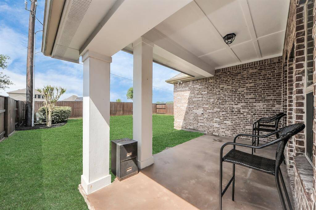 Enjoy relaxing summer days and perfect entertaining on this inviting covered patio.