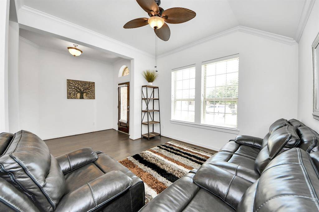 At the front of the home, you'll find a versatile living area that offers endless possibilities. Whether you're looking to create a formal sitting room, a cozy reading nook, a home office, or a stylish entertaining space, this room provides the flexibility to suit your lifestyle.
