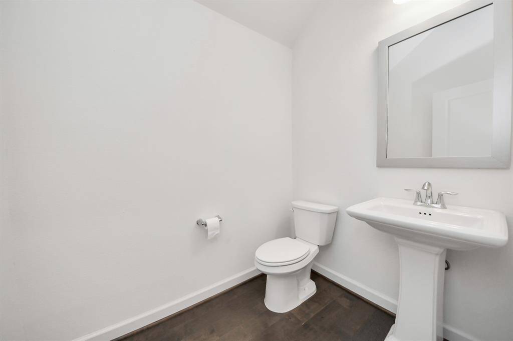 Sleek half bath with modern fixtures, offering convenience and style.