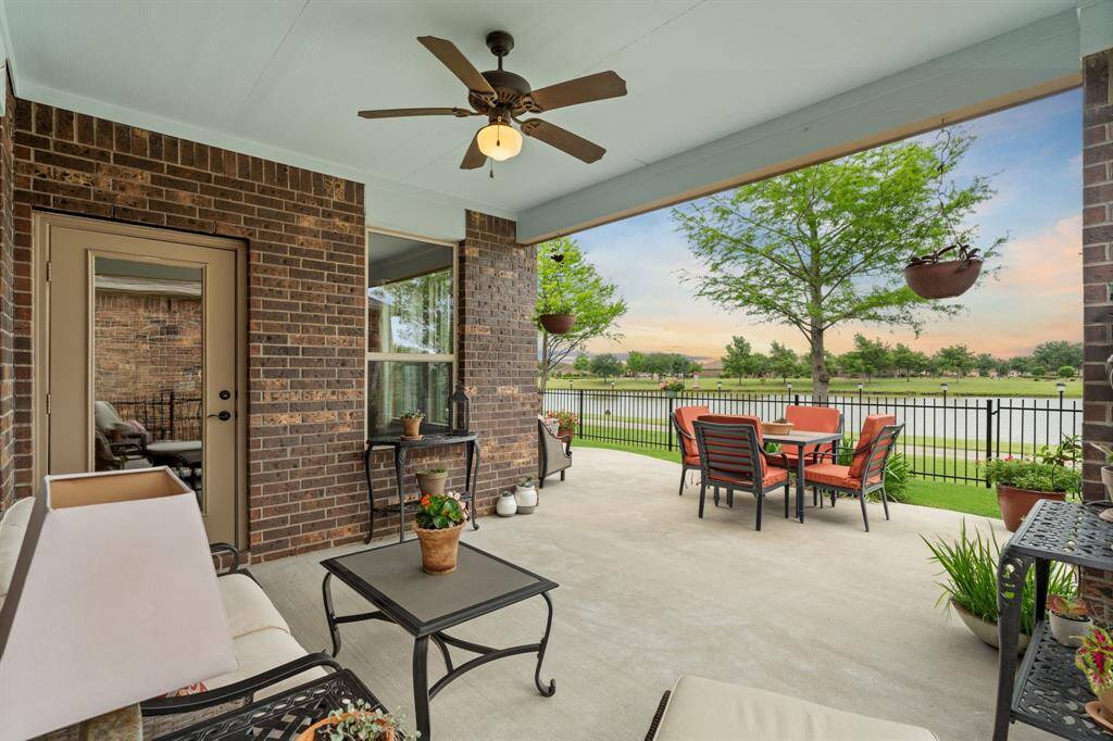 The covered patio with its charming blue ceiling adds extra space to create a cozy outdoor retreat—whether you're placing furniture for relaxation or growing your favorite plants in the fresh air.