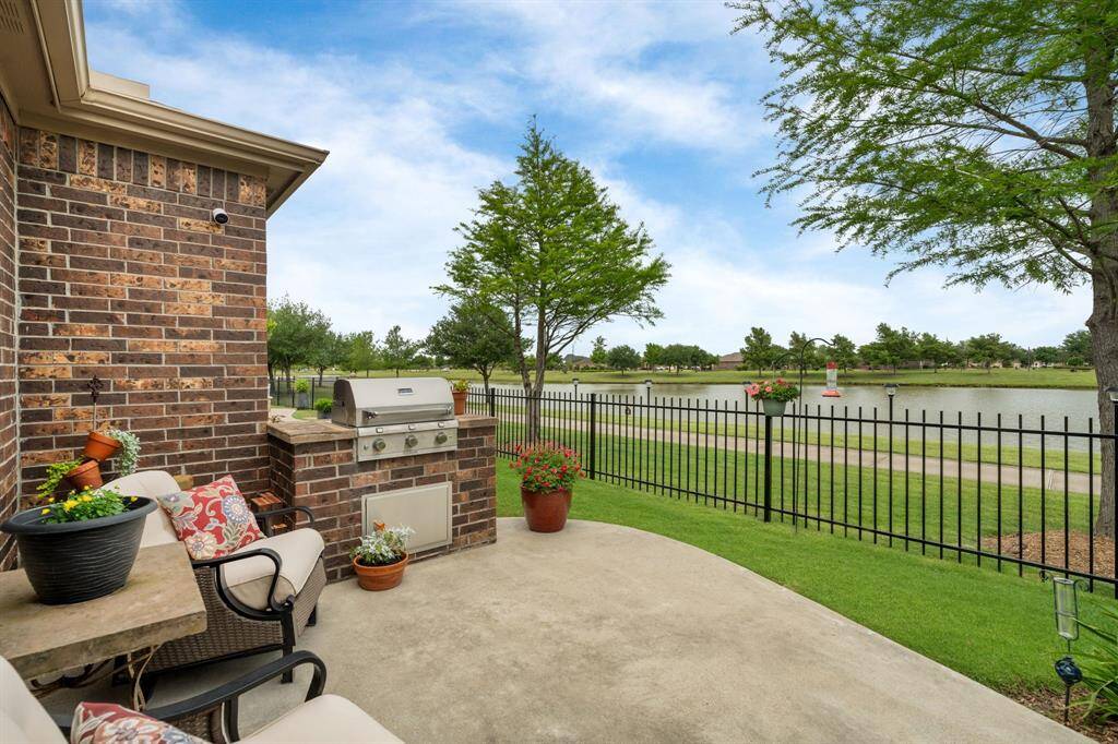 The built-in gas grill with matching brick perfectly complements the home, creating a seamless outdoor space where you can easily host a cookout and enjoy great meals with friends and family.