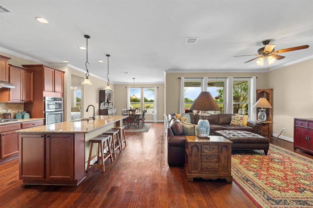 The kitchen, gathering room, and dining area flow together in a bright, open-concept layout—perfect for everyday living and effortless entertaining.