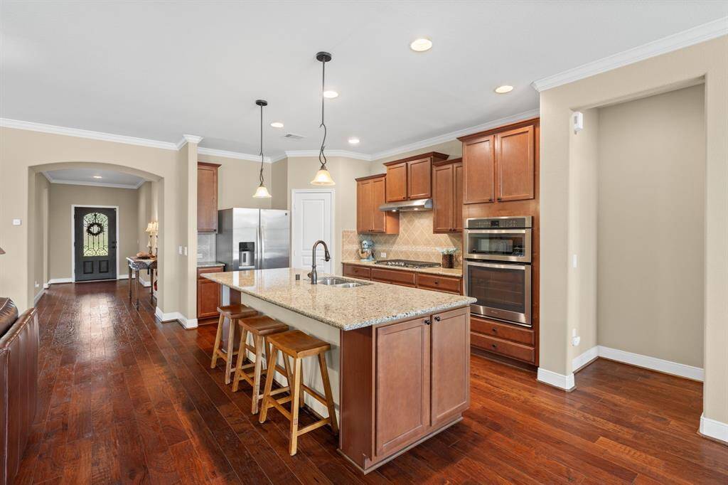 Gorgeous wood flooring flows seamlessly through the main living areas, adding warmth, elegance, and a sense of continuity throughout the home.