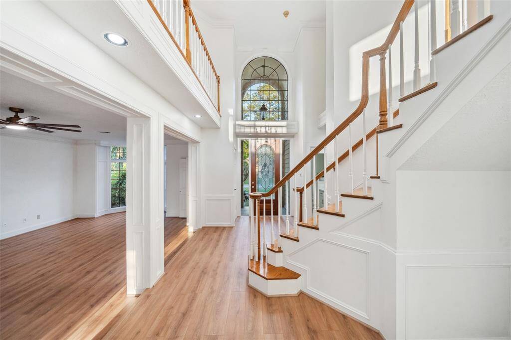 This picture showcases the open and spacious layout of the first floor, highlighting the seamless flow between the living room, dining area, and bar nook.