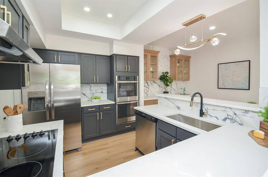 Remodeled kitchen with Sleek, Stylish Stainless & Designer ighting