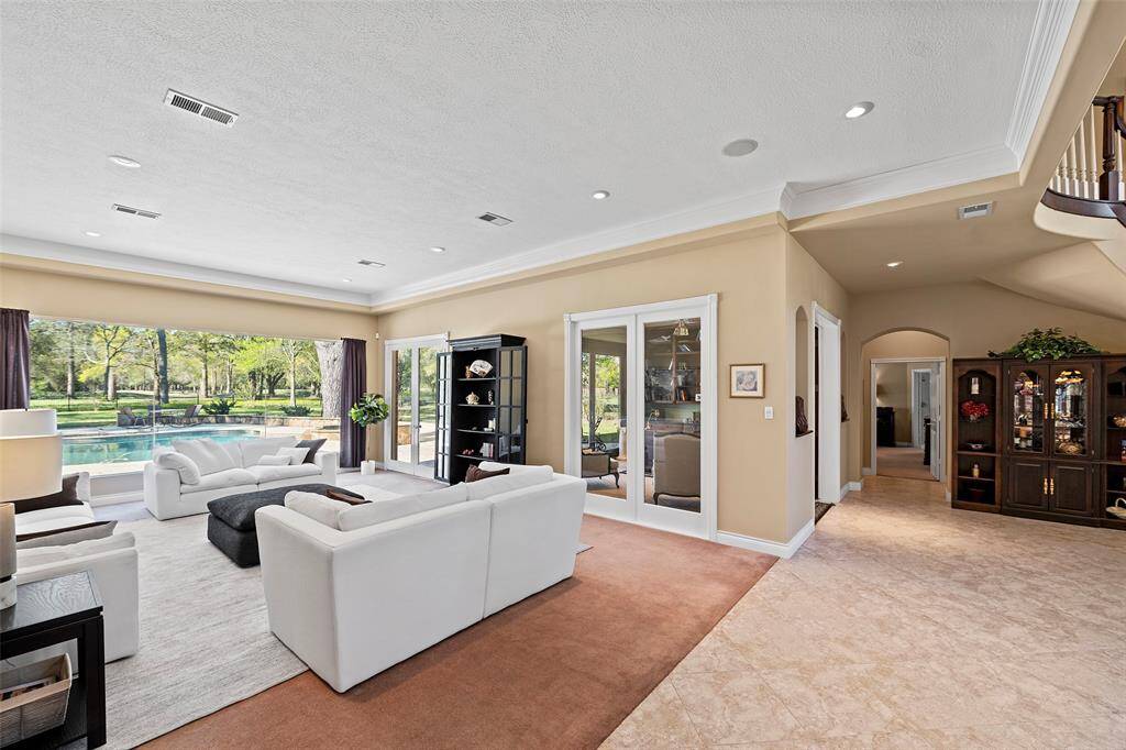 The views in this home are just dazzling, from room to room! The design style of having large glass windows keeping everything open and bright is just genius! Don't have a need for a formal living space, create a downstairs game room or put in a large screen TV, and comfy sectional for the big games in the Fall! This home is wired for speakers so eventually everyone in the home could have a listen!