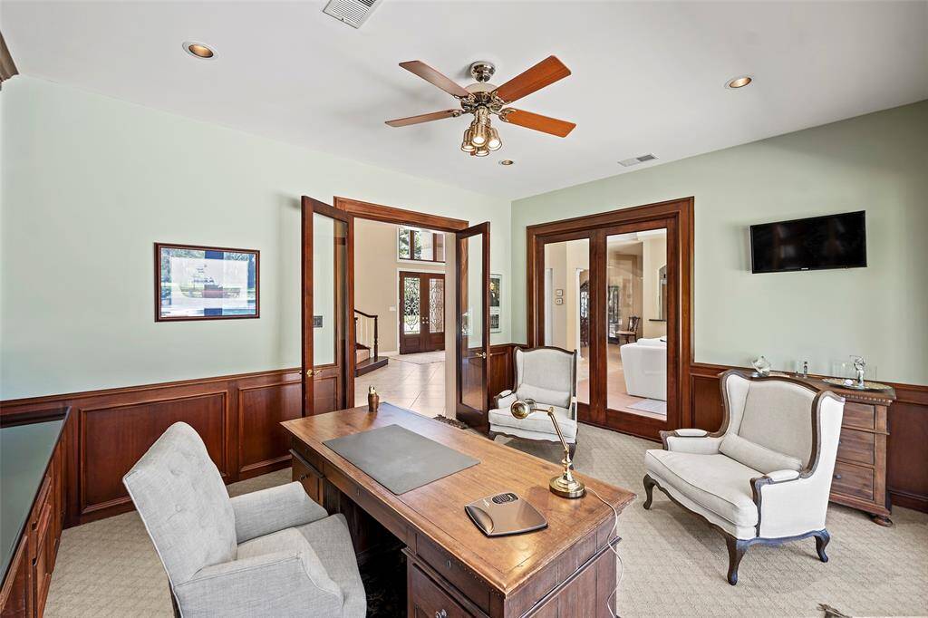 Patterned carpet and dark trim features highlight the awesome views of the backyard space! And we just love the fact that you can slide open the door on a crisp fall day and breathe in the fresh air to calm your senses during a day of work, or play!