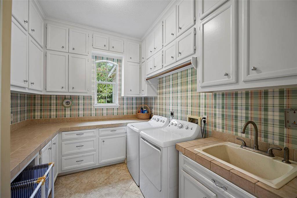 Chores no more! This is an outstanding utility space with a sink for soaking out tough stains, tons of cabinets for storage and a sunny window with views!