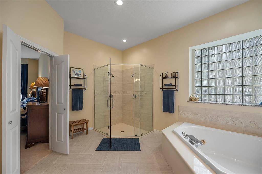 A frameless glass enclosed shower with dual heads will offer a steamy way to wash away the cares of the day! And we'd be remiss if we failed to mention the herringbone patterned tile flooring!