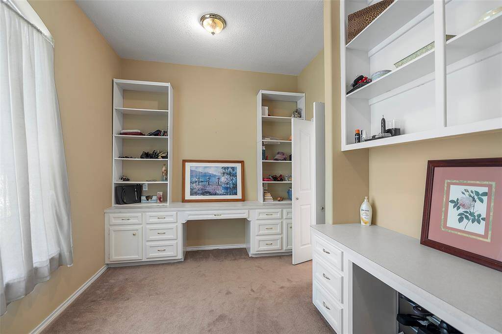 Another FABULOUS feature we love is this dressing area! There is dual knee space, cabinets for storage and shelving for display!