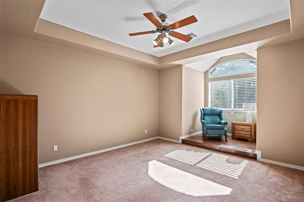 This secondary bedroom has a marvelous step-up nook with arched window with views, ideal for a desk for homework, or a reading spot!