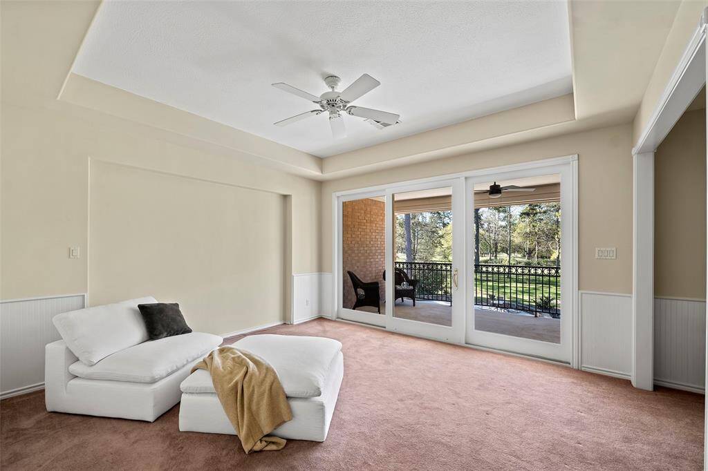 This bedroom has a sliding door with access to a covered patio overlooking the wonderful backyard spaces!