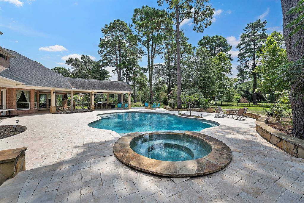 The thoughtful design that went into this backyard is just breathtaking! Gorgeous travertine tile decking expands the entertaining space! There is ample room for pulling up a lounger and soaking in the sun!