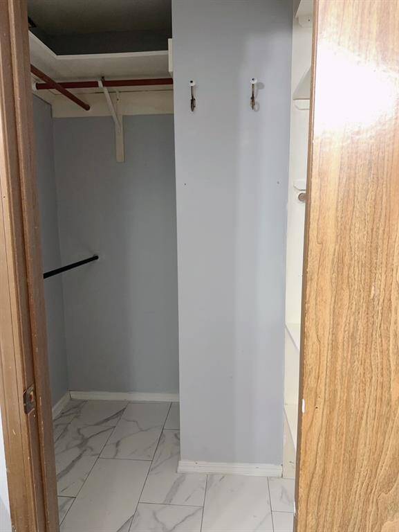 Walk in closet in primary bedroom