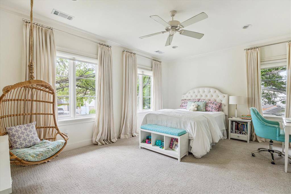 This light-filled secondary bedroom with charming front-facing tree-top views features a full ensuite bath and spacious walk-in closet for added comfort and functionality.