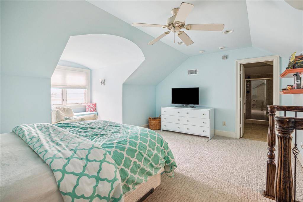 A charming and spacious retreat, the third-floor bunk room or bedroom features vaulted ceilings that add a sense of openness and grandeur. With an ensuite bathroom for added privacy and convenience, this room offers a perfect blend of comfort and style, making it an ideal space for guests or family members.