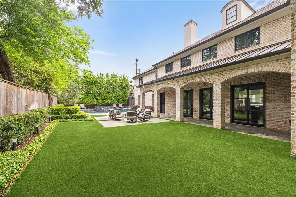 The backyard has been turfed and thoughtfully updated with a drought-tolerant landscape, offering low-maintenance beauty and sustainability. There's plenty of space to host outdoor events or simply relax poolside in a serene setting. An arched, covered walkway lined with brick adds charm and character, providing easy access between indoor and outdoor living spaces—perfect for seamless entertaining and everyday enjoyment.