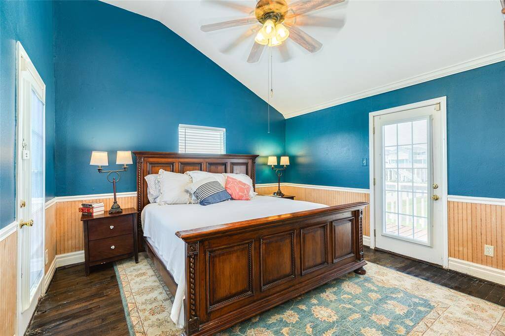 Primary bedroom with entrance to side deck and front deck.
