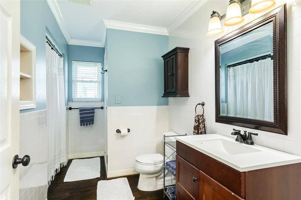 Large secondary bath with walk in shower and utility room.