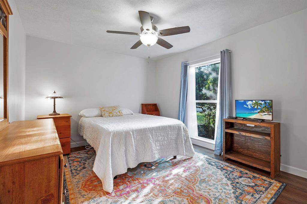Secondary Bedroom with large window for natural lighting creating a warm and inviting atmosphere **403 E Lake Drive, Livingston, TX 77351**