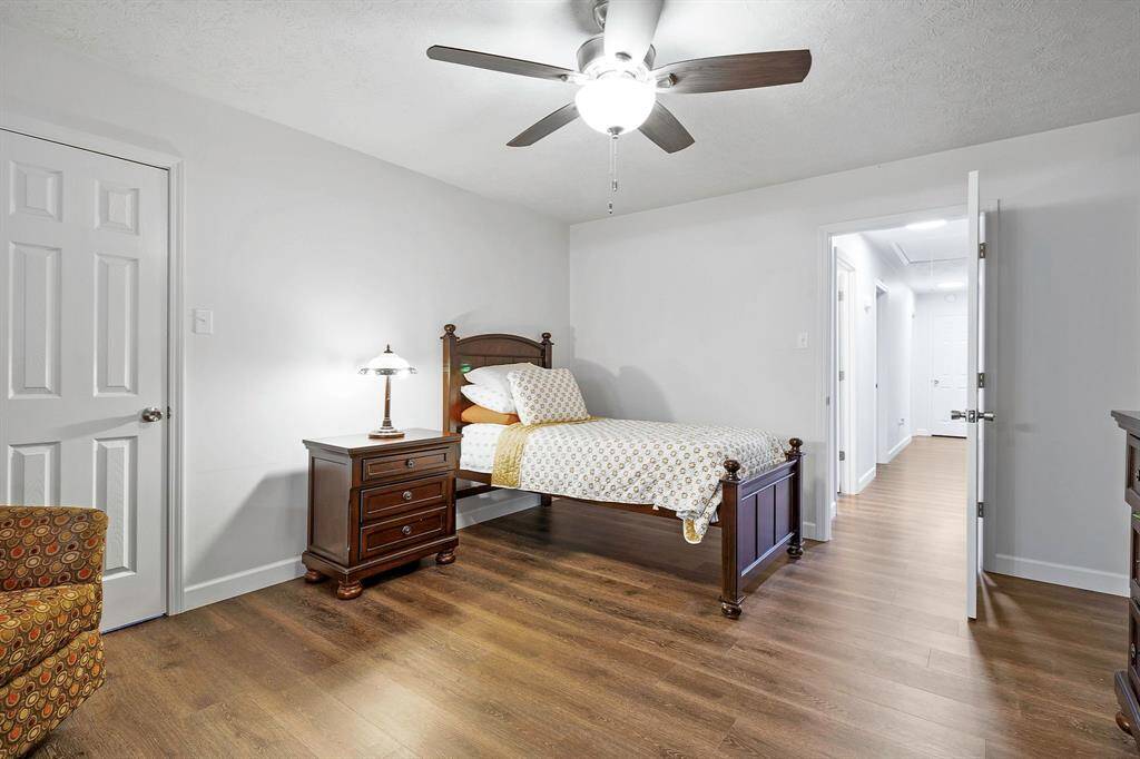 Your en-suite bathroom features a vaulted wooden ceiling, double vanity, dark wood cabinets, modern lighting and access to the waterfront **403 E Lake Drive, Livingston, TX 77351**