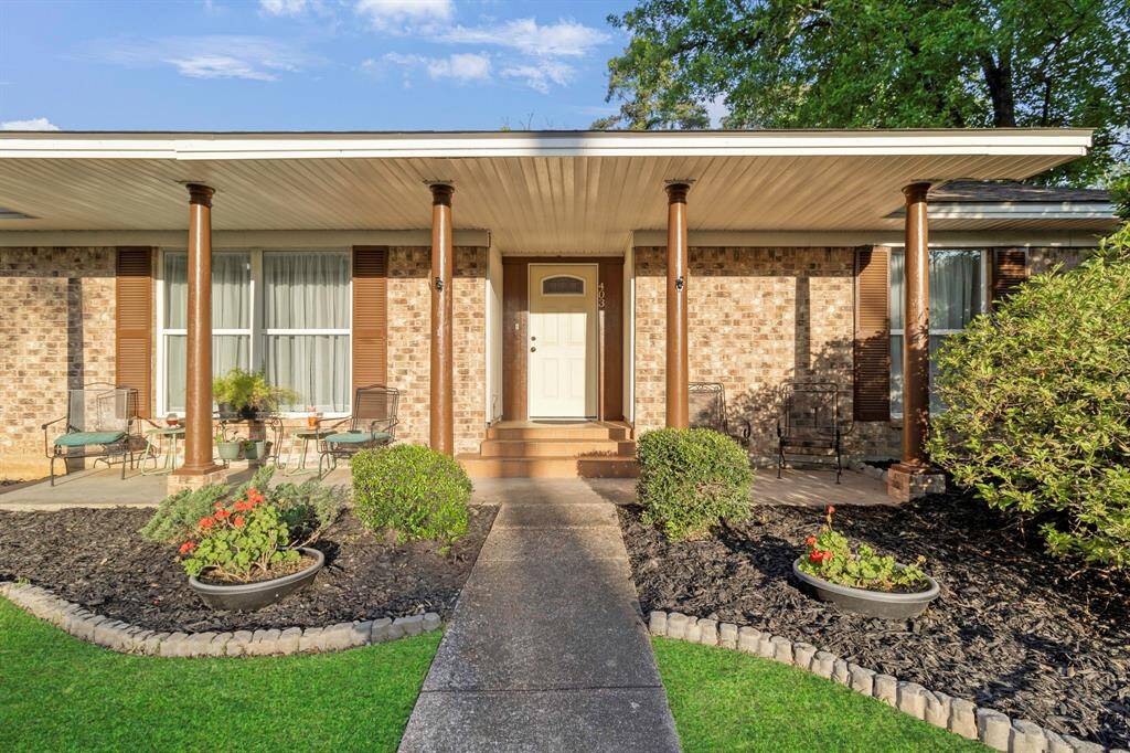 Traditional brick home with a delightful porch and classic columns, enjoy the inviting curb appeal and beautifully maintained flower beds **403 E Lake Drive, Livingston, TX 77351**