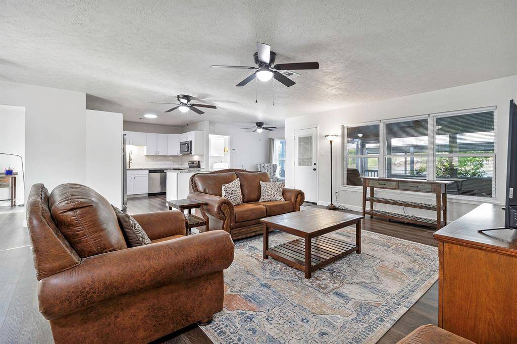 Spacious open concept living area featuring rich luxury vinyl floors and abundant natural light **403 E Lake Drive, Livingston, TX 77351**