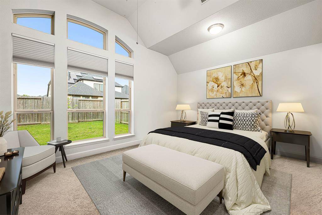 What a wonderful place to come home to! This stunning primary suite greets you with plush carpet floors, neutral paint, high ceiling, ceiling fan with lighting, lovely arched windows with blinds allowing in natural light brightening up this spacious primary bedroom with extra space for a seating area. *virtual staged*
