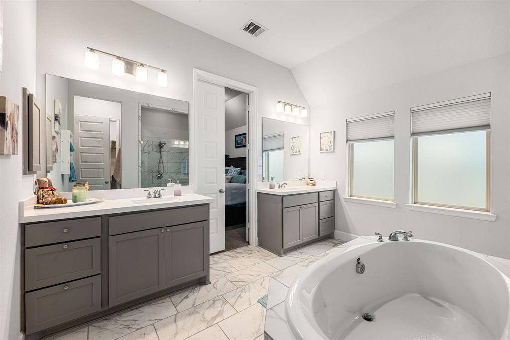 This additional view of the primary bath showcases two sets for your sink and additional counter space.