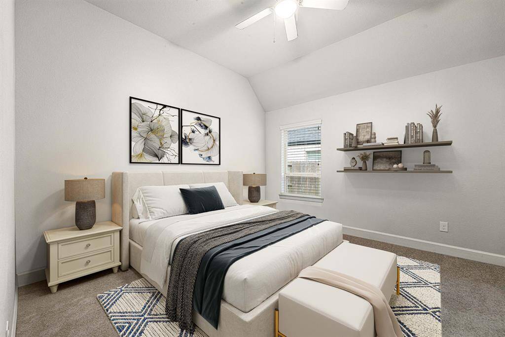 Secondary bedroom features plush carpet, neutral paint, ceiling fan with lighting and a large window with privacy blinds. *virtual staged*