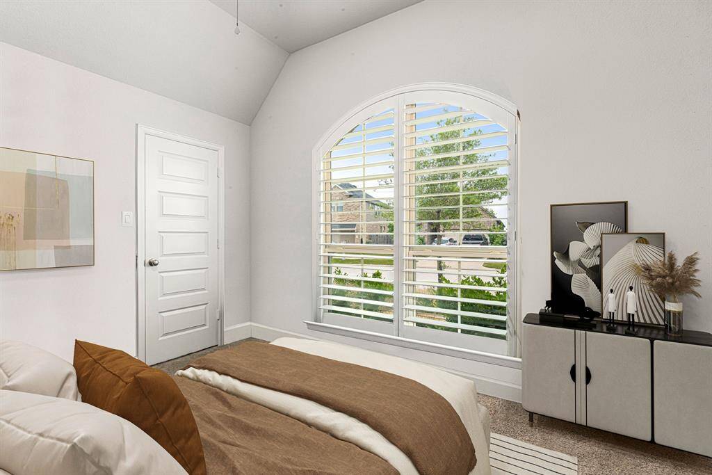 Secondary bedroom features plush carpet, neutral paint, ceiling fan with lighting and a large window with privacy blinds. *virtual staged*