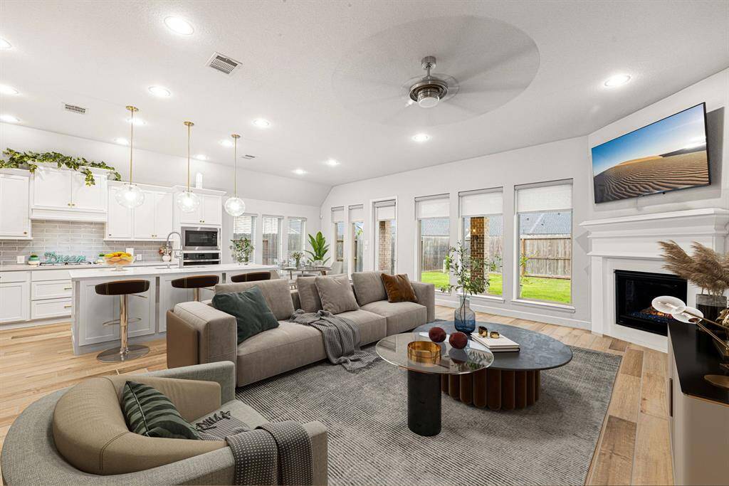 Gather the family and guests together in your lovely living room! Featuring recessed lighting, dark stained ceiling fan, neutral paint, gorgeous wood like tile floors and large windows that provide plenty of natural lighting throughout the day. *virtual staged*