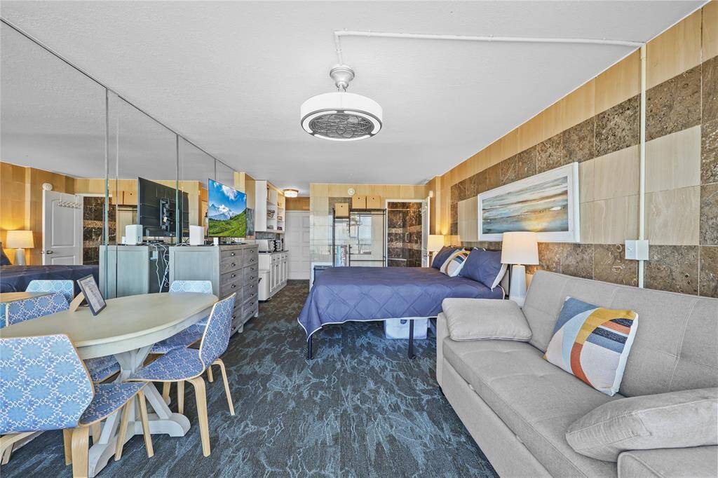 This open-concept layout combines cozy sleeping quarters, a sitting area, a dining nook, and a compact kitchen—all thoughtfully arranged to maximize space and functionality.