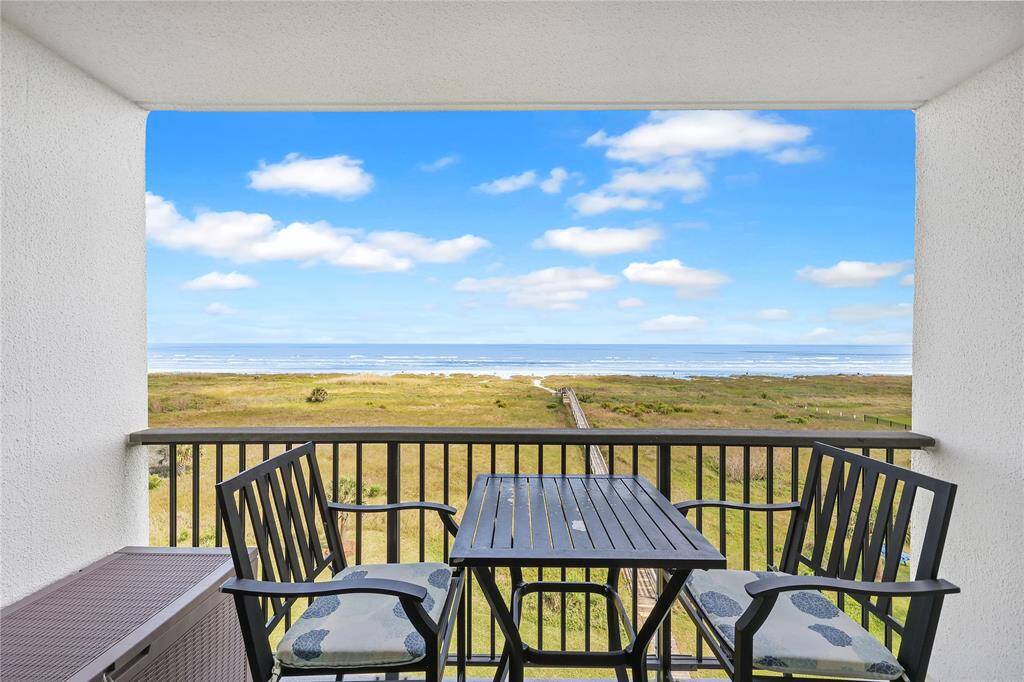 Your private covered balcony overlooks the dunes and sparkling Gulf waters—an ideal setting for dining, sipping morning coffee, or simply enjoying the ocean breeze.