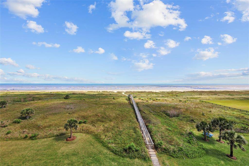 A private crossover leads directly from the property to the sandy shores of Galveston. No streets to cross—just pure beachfront access right outside your door.