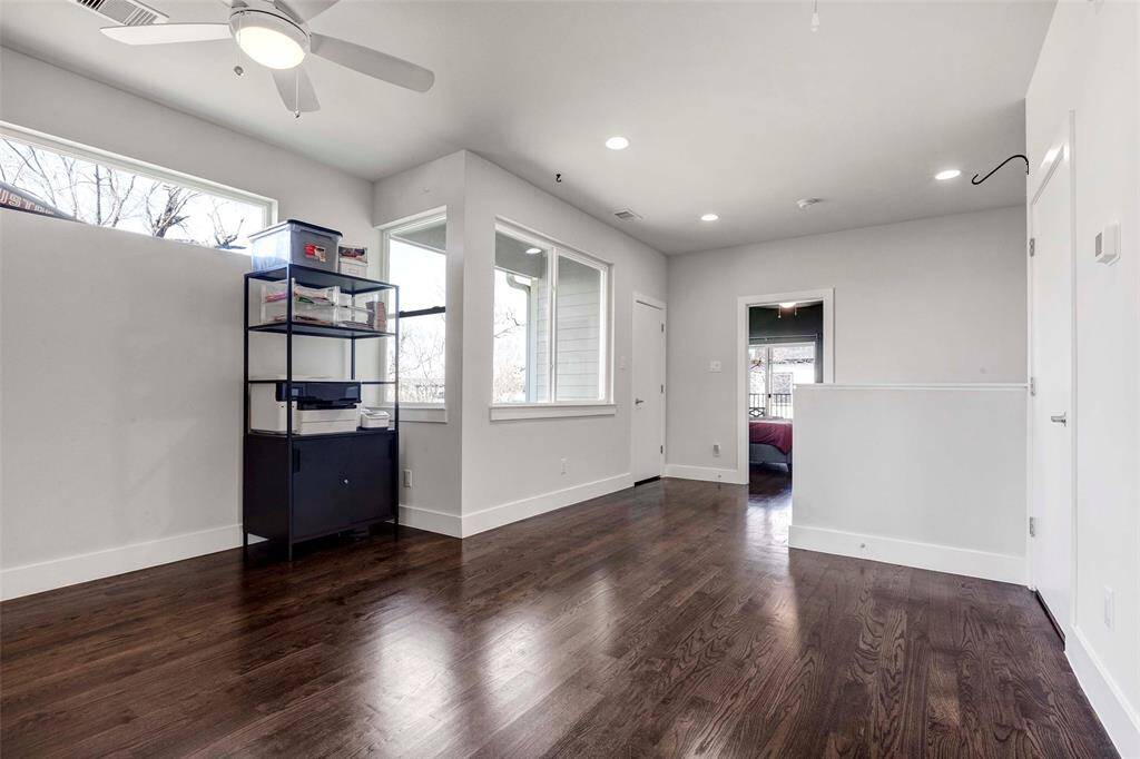 Featuring rich hardwood floors and abundant natural light, this versatile space includes a linen closet in the corner for added convenience and storage.