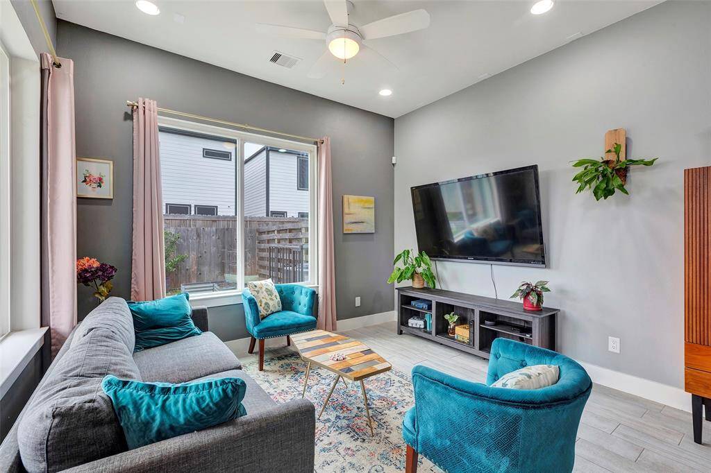 Relax in the spacious living room with a beautiful view of the fenced backyard.