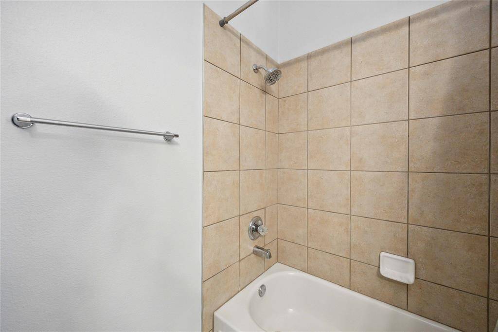 Secondary en-suite bathroom with tub/shower combo.