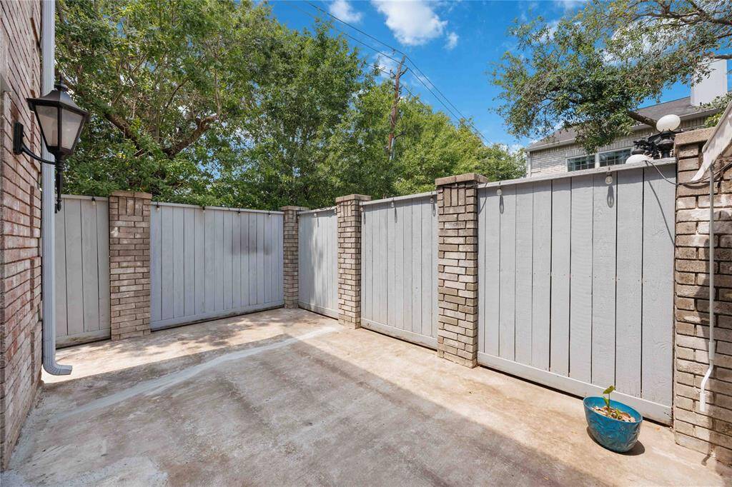 Fenced, private, wraparound patio with access from two sides of the home.
