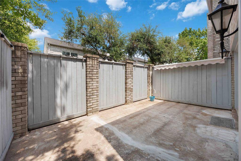 Fenced, private, wraparound patio with access from two sides of the home.