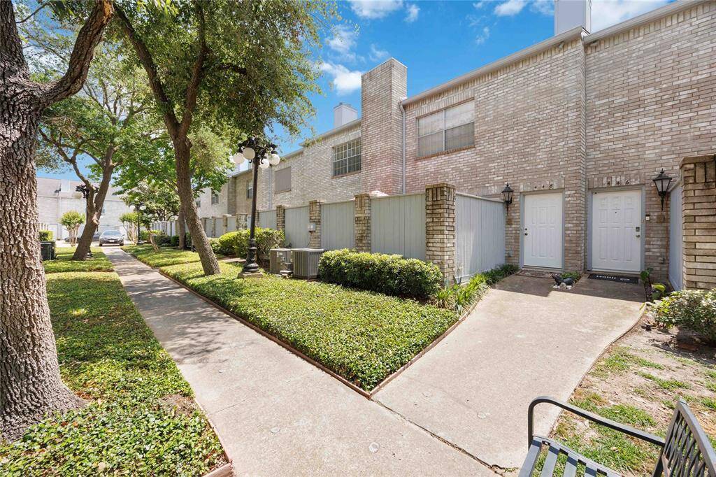 Pathway to unit entrance. Well-maintained community.
