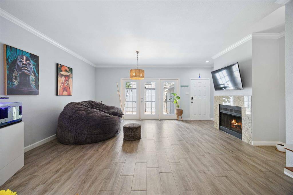Spacious living/dining area with abundance of natural light and a fireplace.